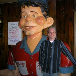 a man standing in front of a statue of a man a man standing in front of a statue of a man