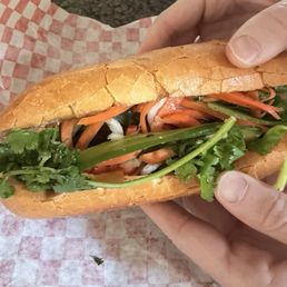 Pork Banh mi, fresh vegetables, crispy bread, and flavorful pork Pork Banh mi, fresh vegetables, crispy bread, and flavorful pork