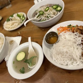 The Rolling Spring Roll - Clockwise: Pho Do Bien (seafood), Pho Bo (beef), Grilled Lemongrass Chicken, stolen broth - Vietnamese Near Me - Syosset, New York The Rolling Spring Roll - Clockwise: Pho Do Bien (seafood), Pho Bo (beef), Grilled Lemongrass Chicken, stolen broth - Vietnamese Near Me - Syosset, New York
