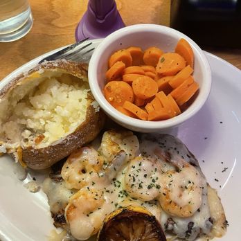 Texas Roadhouse - Herb crusted chicken with added shrimp, potato and carrots. Grilled lemon for garnish - Steakhouses Near Me - Port Arthur, Texas
