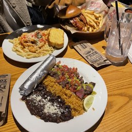 two plates of mexican food on a table two plates of mexican food on a table