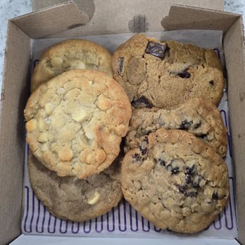 Insomnia Cookies - Chai Latte, White Chocolate Macadamia, Pumpkin Chocolate Chunk and Oatmeal Raisin~looks like the driver broke off a piece from the 2 cookies - Desserts Near Me - Hempstead, New York