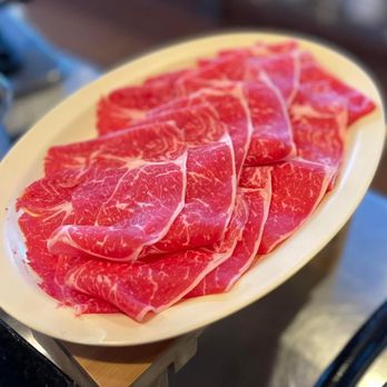 Swish - a plate of sliced meat on a counter - Japanese Near Me - Las Vegas, Nevada Swish - a plate of sliced meat on a counter - Japanese Near Me - Las Vegas, Nevada