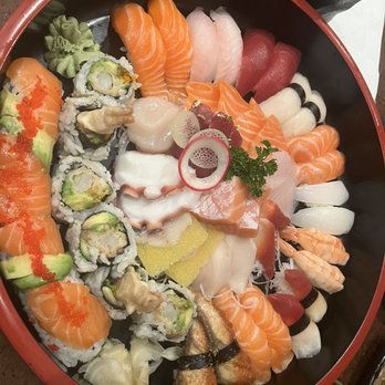 Gal's Sushi - Party tray - A sushi platter featuring sashimi, sushi rolls, and garnishes, including salmon, tuna, shrimp, and octopus, arranged in a circular pattern. - Sushi Bars Near Me - Markham, Ontario