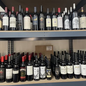 Hot Spot - a shelf full of wine bottles - Beer, Wine & Spirits Near Me - Austin, Texas