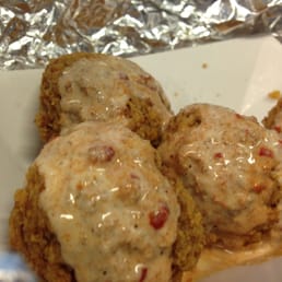 side of falafel with tahini and a little hot sauce