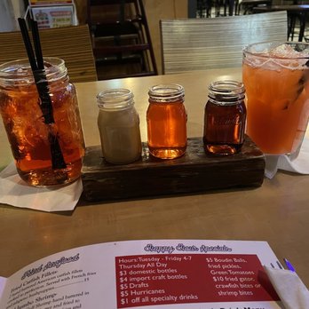 Bucky Moonshine's - Middle: Moonshine flight (butter pecan, hunch punch, blackberry) Right: blackberry moonshine drink - Cajun/Creole Near Me - Dallas, Texas Bucky Moonshine's - Middle: Moonshine flight (butter pecan, hunch punch, blackberry) Right: blackberry moonshine drink - Cajun/Creole Near Me - Dallas, Texas