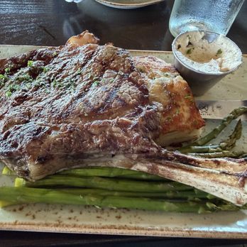 Downriggers - Medium rare bone-in ribeye steak over mashed potatoes with asparagus - American Near Me - Friday Harbor, Washington