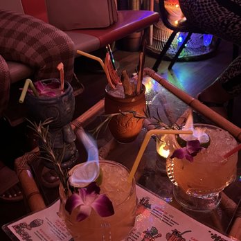 Mutiny Tiki Bar - two cocktails on a table - Tiki Bars Near Me - Detroit, Michigan Mutiny Tiki Bar - two cocktails on a table - Tiki Bars Near Me - Detroit, Michigan