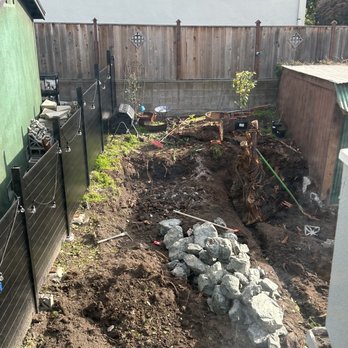Intuitive Landscape & Construction - Half way progress shot - taking out a huge redwood stump from the back yard. - Landscaping Near Me