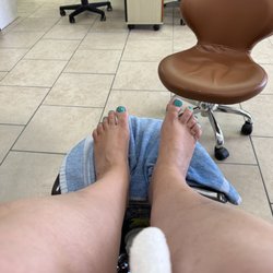 Fantasy Nails - Lower legs and feet, showing Caribbean blue nail polish.