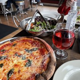 a pizza and a salad on a table