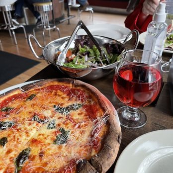 A W Wander - a pizza and a salad on a table - Beer Bar Near Me - Manlius, New York