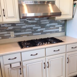 RG Construction - Removed old cabinets, installed new custom cabinets with new stove top and ventahood.  Installed tile backsplash.