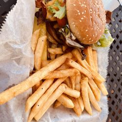 Muddy Creek Cafe & Music Hall - Med Rare Muddy Pepper Bacon Cheddar Cheese Burger and fries. Absolutely delicious!