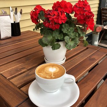Commercial Street Cafe - a cup of cappuccino on a wooden table - Cafes Near Me - Vancouver, British Columbia