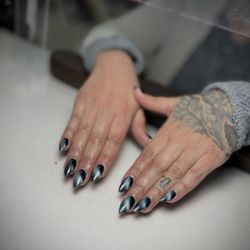 Crystal Nail & Spa - Elegant black cat-eye nails for a chic and mysterious vibe