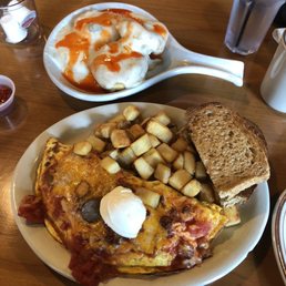 Spanish omelette with sausage and chorizo, pheasant potatoes, and a side of biscuits with gravy.