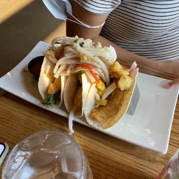Baxters Landing - a person sitting at a table with a plate of food - Burgers Near Me - Oshawa, Ontario