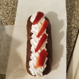 Chocolate Frosted Long John with Whipped Cream and Strawberries Chocolate Frosted Long John with Whipped Cream and Strawberries