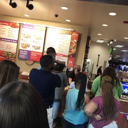 a crowd of people standing in line to order pizza a crowd of people standing in line to order pizza