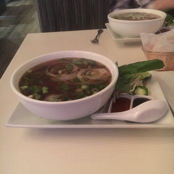 Basilic Vietnamese Grill - Two bowls of pho. Grilled beef (bottom) and combination (top). - Vietnamese Near Me - North Miami, Florida Basilic Vietnamese Grill - Two bowls of pho. Grilled beef (bottom) and combination (top). - Vietnamese Near Me - North Miami, Florida