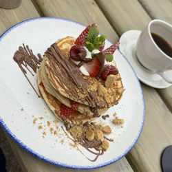 Olive's Room - Adult portion of pancakes with strawberries, chocolate, cookie crumbs, and whipped cream. €13