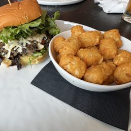 Veggie burger & tots, iced green tea in the background