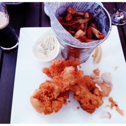 Fish & chips served with a small black beer Fish & chips served with a small black beer