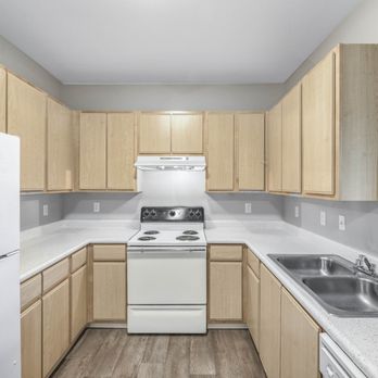 Geneva Pointe - Galley kitchen with electric range and light wood cabinetry - Apartments Near Me - Elk Grove, California Geneva Pointe - Galley kitchen with electric range and light wood cabinetry - Apartments Near Me - Elk Grove, California