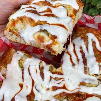 Pie of the Tiger - a hand holding a piece of pizza - Pizza Near Me - Columbus, Ohio Pie of the Tiger - a hand holding a piece of pizza - Pizza Near Me - Columbus, Ohio