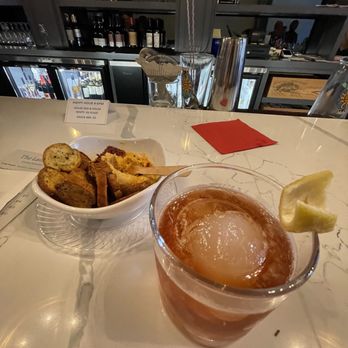 The Laundry - a glass of tea and a bowl of bread - Bars Near Me - Columbus, Ohio