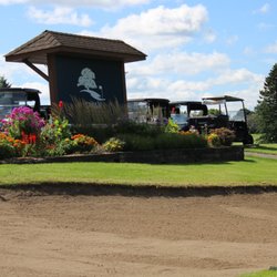 Scoreboard behind hole 18 with Dwan Golf Course logo.