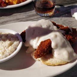 Biscuits and gravy with chicken strips, and grits