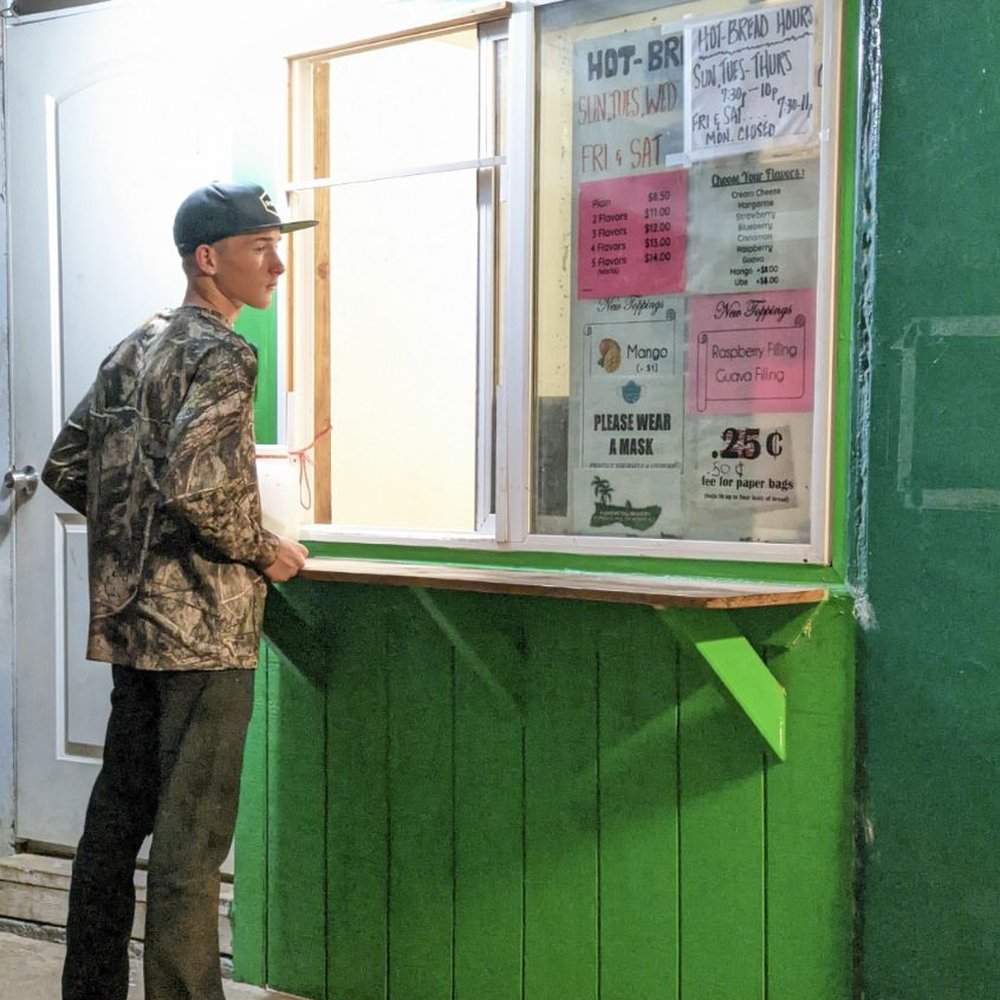 Young man waits patiently for hot bread.