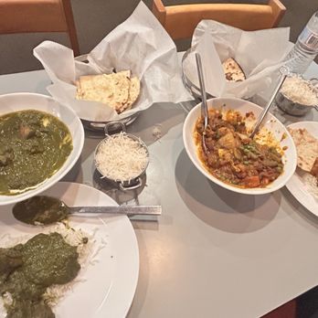 Noor Biryani Indian Grill - A spicy lamb dish on the right and a mild Garlic Naan on the left. - Indian Near Me - Suffern, New York Noor Biryani Indian Grill - A spicy lamb dish on the right and a mild Garlic Naan on the left. - Indian Near Me - Suffern, New York