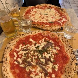 Anchovies with capers and a double margherita pizza. Anchovies with capers and a double margherita pizza.