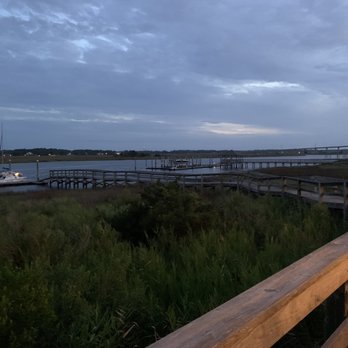 Rusty Hooks Dockside Grill - a view of a dock at dusk - Seafood Near Me - Southport, North Carolina Rusty Hooks Dockside Grill - a view of a dock at dusk - Seafood Near Me - Southport, North Carolina