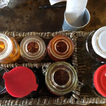 Nudi - CLOCKWISE:pickled peppers, pepper flakes, pepper w/ oil, clean spoons, dirty spoons, pepper paste (spicy), soy sauce, fish sauce - Asian Fusion Near Me - Portland, Oregon