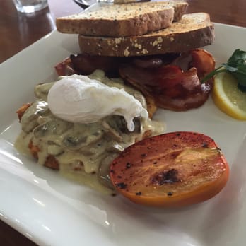 Cafe 63 - Emirates: potato rosti stack with creamy mushrooms topped with a poached egg, roast tomato, bacon and toast. AUD$14 - Cafes Near Me - New Farm, QLD