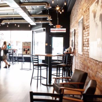 Five Lakes Coffee - a woman walking past a bar - Coffee & Tea Near Me - Sturgis, Michigan