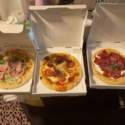 Chez Livio - 3 pizzas:  On left - ham & mushroom,; center - the delux; on right - prosciutto, olives, & sun dried tomatoes