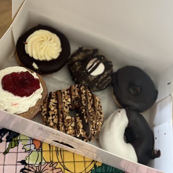 Doughology - Lynbrook - Boston cream, s'mores, chocolate frosted, strawberry shortcake, snickers, black & white. All yum! - Donuts Near Me - Lynbrook, New York