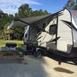 Cedar Key Rv Resorts - Campsite by dog fenced in area.