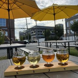 four glasses of beer on a wooden table four glasses of beer on a wooden table