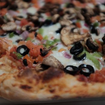 The Pizza Box - a closeup of a pizza with mushrooms, peppers, and black olives - Pizza Near Me - Milpitas, California