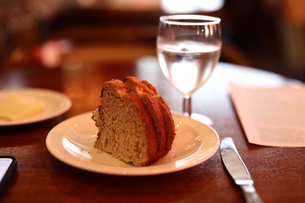 Photo of Vintage Press - Visalia, CA, US. a slice of cake and a glass of water