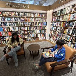 Large selection of books and comfy chairs to read in