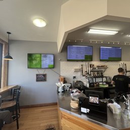 a man working at a coffee shop a man working at a coffee shop
