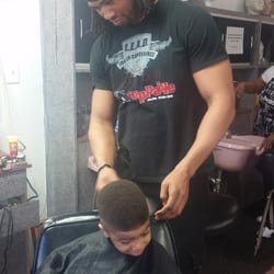 Jermaine's Golden Clippers - Jermaine at work in my son's hair, getting him ready for his trip!